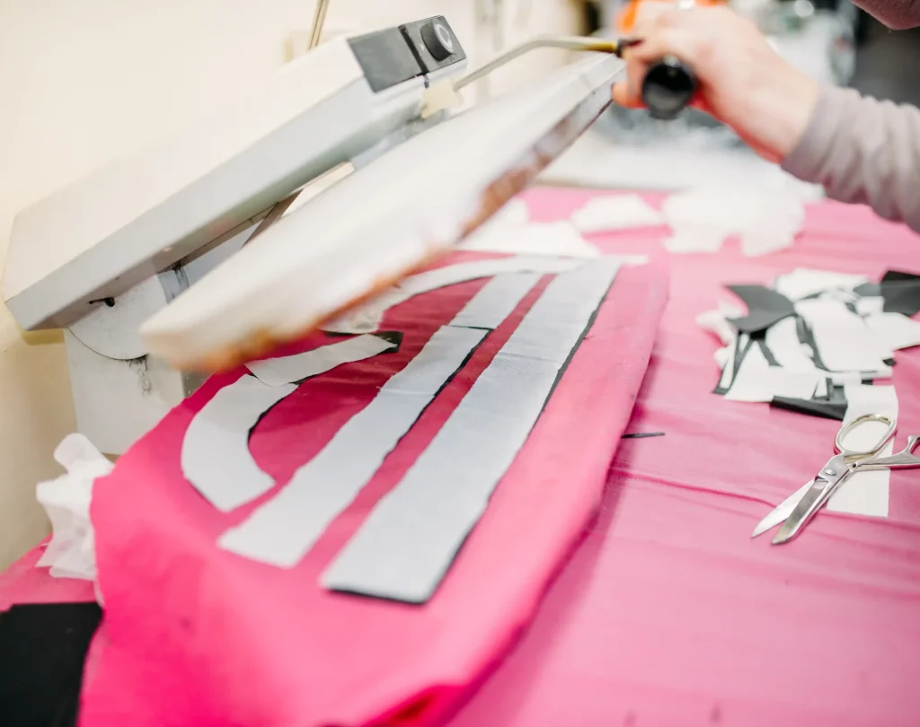 clothes-designer-works-on-steam-press-2026-03-13-01-57-03-utc