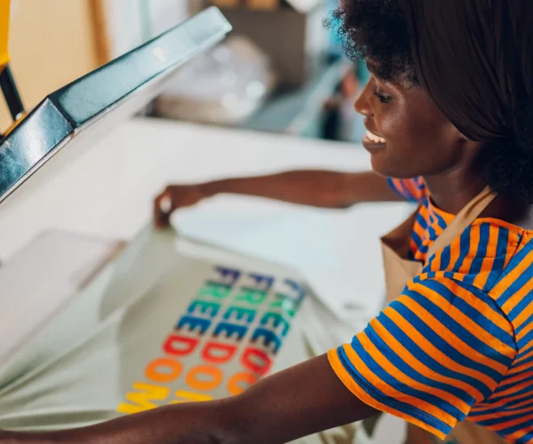 interracial-worker-putting-t-shirt-on-heating-pres-2026-03-25-00-51-08-utc